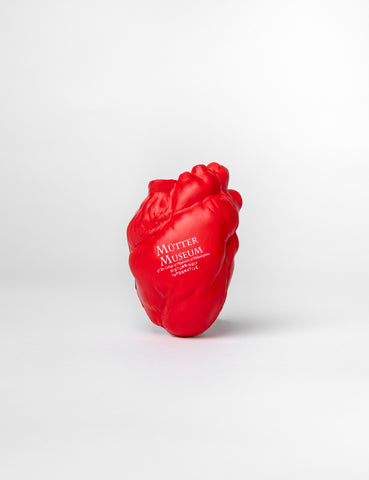 A red foam squeeze toy in the shape of a heart with the Mütter Museum logo in white imprinted on it.
