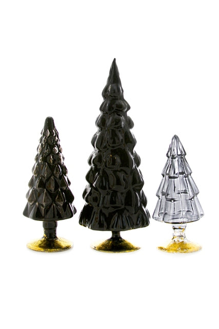 Three different glass statues of trees in three different shades of black.