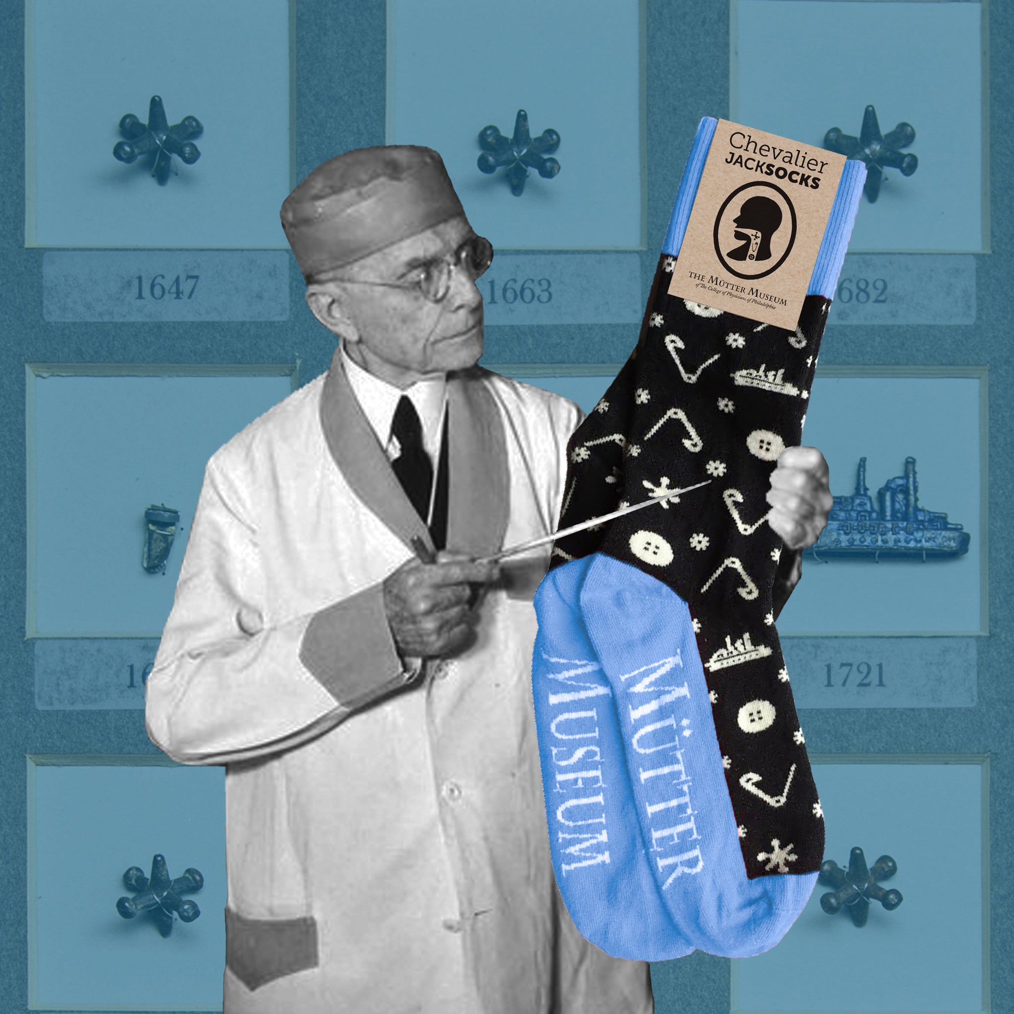 A pair of black socks with blue heels, toes, and ankles. There are white pictures of safety pins, buttons, and a ship on it. There is a photo of Dr. Jackson pointing at the socks with an image of one of the Chevalier Jackson drawers in the background.
