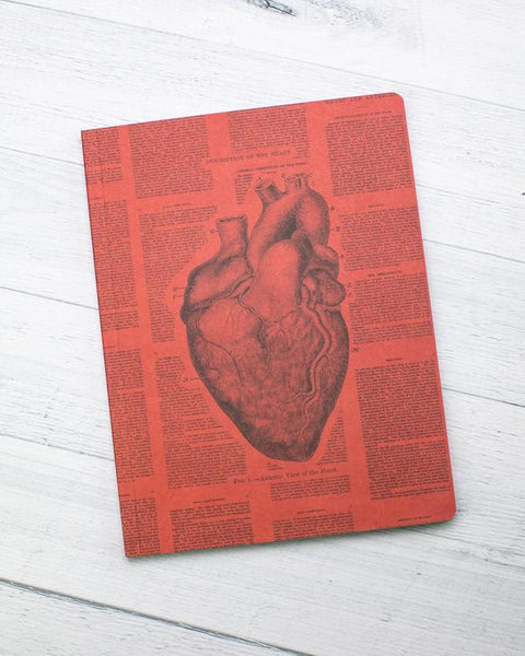 A red notebook with an illustration of a heart in the center and text surrounding it.