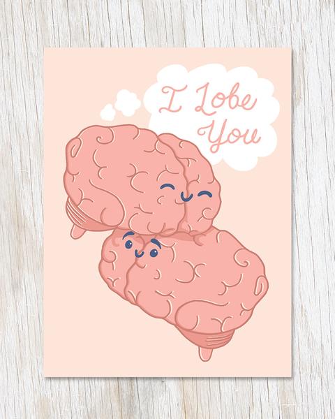 A cream card with an illustration of two pink brains cuddling. Each one has a small face and there is a thought bubble with "I Lobe You" written in it.