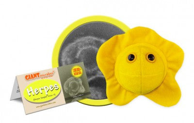 A yellow plush in the shape of Herpes with two eyes with yellow irises next to a card that reads "Herpes."