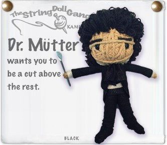 A doll made of string depicting Dr. Mütter. He has black curly hair, black pants and shirt, a flowing black ascot, and a small scalpel in his hand.